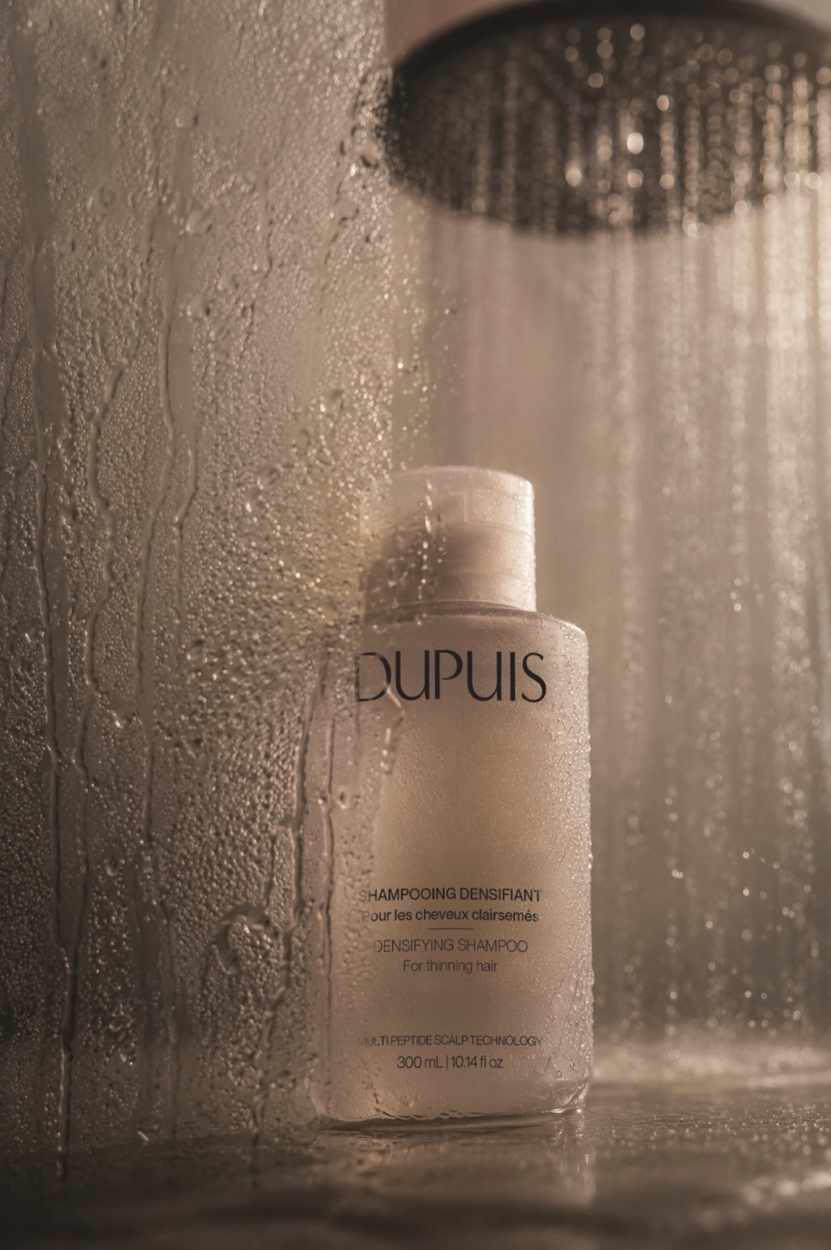 DUPUIS Densifying Shampoo under a rain shower