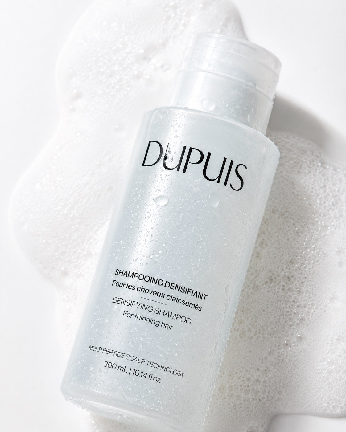 Shampooing Densifiant DUPUIS posé sur une mousse onctueuse sans sulfate